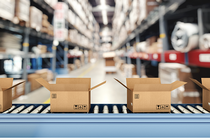 Cardboard boxes on conveyor rollers inside a warehouse ready to be shipped by courier for distribution