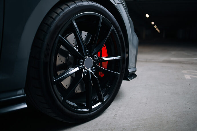 Photo of Black Tire rim with Red Brake Caliper