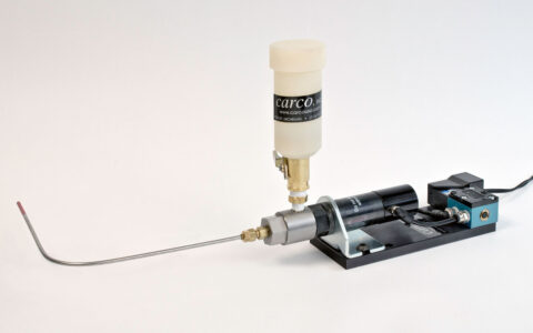 Precision dispensing system with a pressure regulator and nozzle, ideal for industrial applications.