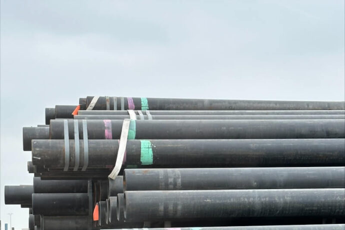 Stack of pipes marked with different colored inks